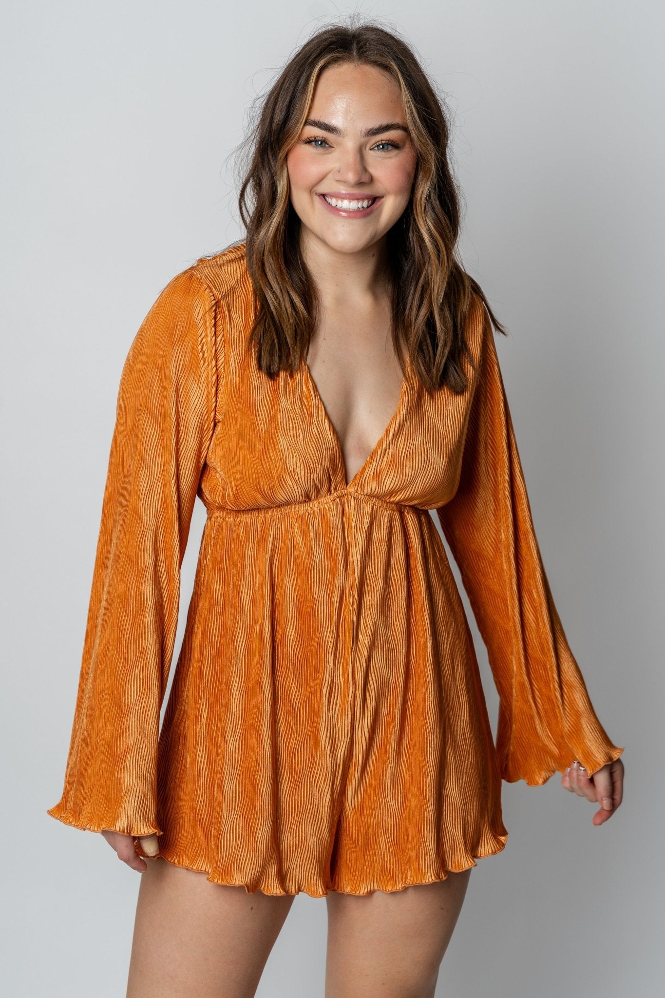 Rompers + Pantsuits | Lush Fashion Lounge: cute boutique pantsuits, trendy boutique rompers, affordable online womens boutiques, cute women’s boutique clothes, urban chic women’s clothing, boutiques in OKC. Model wearing bell sleeve pleated romper 