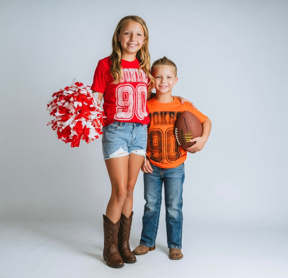 KIDS Gameday | Lush Fashion Lounge Oklahoma City: OKC youth apparel, Oklahoma football kids apparel, Oklahoma Sooners youth sweatshirt, OKC kids t shirts, Oklahoma kids apparel. Young girl wears red OU shirt and young boy wears orange osu shirt 