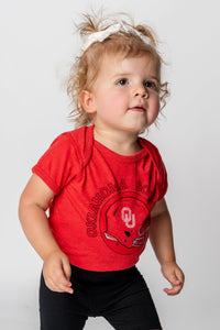 OU Kids OU helmet circle onesie red Onesie | Lush Fashion Lounge Trendy Oklahoma University Sooners Apparel & Cute Gameday T-Shirts